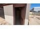 Interior of a cement block storage shed with a wooden door under a blue sky at 6104 W Marconi Ave, Glendale, AZ 85306