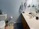 Bathroom featuring blue wall, white sink and toilet at 6637 E Culver St, Scottsdale, AZ 85257