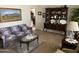 Inviting living room with floral sofa, glass coffee table, and vintage hutch showcasing decorative dishware at 6637 E Culver St, Scottsdale, AZ 85257