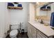 This bathroom features a toilet, sink and wooden shelves at 6901 E Oak St, Scottsdale, AZ 85257