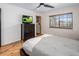Cozy bedroom featuring a bed, dresser, ceiling fan, and a large window at 6901 E Oak St, Scottsdale, AZ 85257