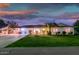 Charming single-story home featuring a lush green lawn, covered parking, and manicured landscaping at 6901 E Oak St, Scottsdale, AZ 85257