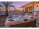 Inviting hot tub under string lights with a landscaped yard, perfect for relaxing evenings at 6901 E Oak St, Scottsdale, AZ 85257