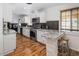 Well-lit kitchen with granite countertops, stainless appliances, and a cozy breakfast bar at 6901 E Oak St, Scottsdale, AZ 85257
