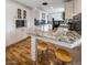 Stylish kitchen featuring granite countertops, breakfast bar seating, and ample white cabinetry at 6901 E Oak St, Scottsdale, AZ 85257