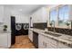 Bright kitchen featuring granite countertops, stainless steel appliances, black tile backsplash and modern fixtures at 6901 E Oak St, Scottsdale, AZ 85257