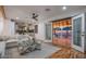 Living room with a view of a pool, hardwood floors, an open layout, and a modern fan at 6901 E Oak St, Scottsdale, AZ 85257