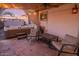 This covered patio has stone floors, a hot tub, and outdoor seating at 6901 E Oak St, Scottsdale, AZ 85257