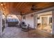 This covered patio has stone floors and outdoor seating next to a hot tub at 6901 E Oak St, Scottsdale, AZ 85257