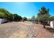 Lush trees and landscape adorn the backyard, offering serene desert vibes for outdoor enjoyment and relaxation at 6940 W Willow Ave, Peoria, AZ 85381
