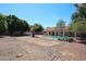 Sparkling pool and lush trees create a tranquil and inviting backyard perfect for relaxation and entertainment at 6940 W Willow Ave, Peoria, AZ 85381