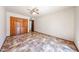 Bright bedroom with tile floors, a ceiling fan, and closet space at 6940 W Willow Ave, Peoria, AZ 85381