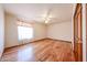 Bedroom with hardwood floors, neutral colored walls, ceiling fan, and closet space at 6940 W Willow Ave, Peoria, AZ 85381