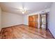 Spacious bedroom featuring wood floors, a ceiling fan, and a wooden closet at 6940 W Willow Ave, Peoria, AZ 85381