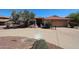 Well-maintained home with desert landscaping, spacious driveway, and red tile roof under a beautiful blue sky at 6940 W Willow Ave, Peoria, AZ 85381