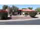 Charming single-story home featuring a tile roof, desert landscaping, and mature trees at 6940 W Willow Ave, Peoria, AZ 85381