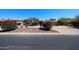 Attractive one-story home with mature desert landscaping, spacious driveway, and red tile roof under clear blue skies at 6940 W Willow Ave, Peoria, AZ 85381