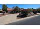 Desert landscaping with mature trees and shrubs complement the red tile roof of this well-maintained home at 6940 W Willow Ave, Peoria, AZ 85381