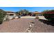 Mature desert landscaping, shrubs, and drought-tolerant foliage complements this home with a red tile roof and stucco exterior at 6940 W Willow Ave, Peoria, AZ 85381