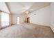 Large living room with a ceiling fan and neutral carpet at 6940 W Willow Ave, Peoria, AZ 85381
