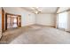 Large living room with neutral carpet and a ceiling fan at 6940 W Willow Ave, Peoria, AZ 85381