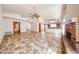 Spacious open floor plan connecting the living area and kitchen with brick fireplace at 6940 W Willow Ave, Peoria, AZ 85381