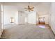 Bright living room with tile entry, carpet, ceiling fan, and arched doorways at 6940 W Willow Ave, Peoria, AZ 85381