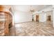Open concept living room featuring a brick fireplace and tile flooring at 6940 W Willow Ave, Peoria, AZ 85381