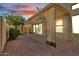 Cozy backyard with a covered patio, decorative rock landscaping, mature trees, and privacy fencing at 7006 E Jensen St # 48, Mesa, AZ 85207