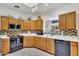 Efficient kitchen layout with wooden cabinets, modern appliances, and ample counter space at 7006 E Jensen St # 48, Mesa, AZ 85207