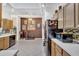 Spacious kitchen with wood cabinets, tiled floors, and an open layout to the dining area at 7006 E Jensen St # 48, Mesa, AZ 85207