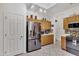 Well-lit kitchen featuring modern appliances, wood cabinetry, and easy access to dining area at 7006 E Jensen St # 48, Mesa, AZ 85207