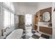 Stunning bathroom boasts a freestanding tub, glass-enclosed shower, and designer vanity at 802 N Lisbon Dr, Chandler, AZ 85226