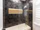 Luxurious bathroom with a soaking tub and black tile surround at 802 N Lisbon Dr, Chandler, AZ 85226