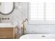 Stylish bathroom features a luxurious soaking tub, brass faucet, and white marble accents at 802 N Lisbon Dr, Chandler, AZ 85226