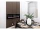 Sophisticated dining space boasts an electric fireplace, designer table setting, and modern decor at 802 N Lisbon Dr, Chandler, AZ 85226