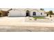 Charming single-Gathering home boasting a well-manicured front yard, three car garage and neutral color palette at 802 N Lisbon Dr, Chandler, AZ 85226