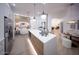Beautiful kitchen with stainless steel refrigerator and large island flows into a stylish living area at 802 N Lisbon Dr, Chandler, AZ 85226