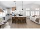 Modern kitchen features white cabinetry, stainless steel appliances, and a spacious island with seating at 802 N Lisbon Dr, Chandler, AZ 85226