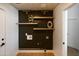 Laundry room with open shelving and designer wallpaper at 802 N Lisbon Dr, Chandler, AZ 85226