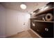 Laundry room with open shelving and designer wallpaper at 802 N Lisbon Dr, Chandler, AZ 85226