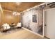 Beautiful living room with wood paneling, artistic wallpaper, modern lighting, and cozy seating at 802 N Lisbon Dr, Chandler, AZ 85226