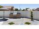 Outdoor kitchen area with built in grill and countertops for a relaxed backyard at 802 N Lisbon Dr, Chandler, AZ 85226