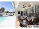 Comfortable outdoor patio area with stylish furniture, ceiling fan, and a view of the pool and backyard at 802 N Lisbon Dr, Chandler, AZ 85226