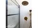 Modern shower with bronze fixtures, glass enclosure, and white tile at 802 N Lisbon Dr, Chandler, AZ 85226