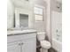 Bright bathroom featuring a vanity, mirror, window, toilet, and shower-tub combo at 823 E Agua Fria Ln, Avondale, AZ 85323