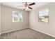 Bedroom with neutral carpet, ceiling fan, and natural light from the windows at 823 E Agua Fria Ln, Avondale, AZ 85323