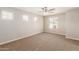 Bedroom with neutral carpet, ceiling fan, and natural light from the windows at 823 E Agua Fria Ln, Avondale, AZ 85323