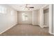 Bedroom with neutral carpet, ceiling fan, and natural light from the window at 823 E Agua Fria Ln, Avondale, AZ 85323