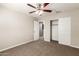 Bedroom features neutral paint, carpeted floors, ceiling fan and closet with double doors at 823 E Agua Fria Ln, Avondale, AZ 85323